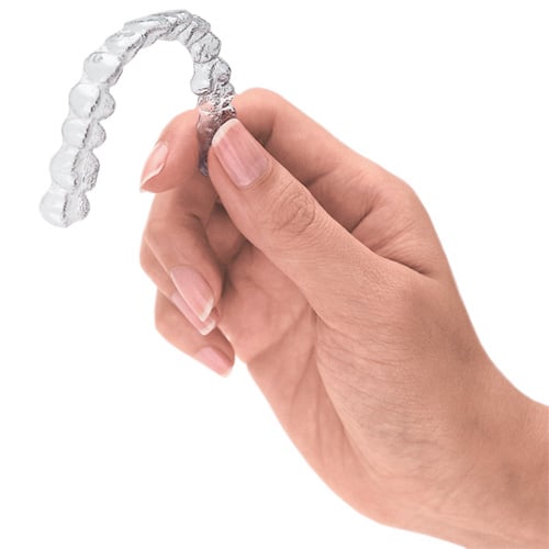 Hand holding invisalign